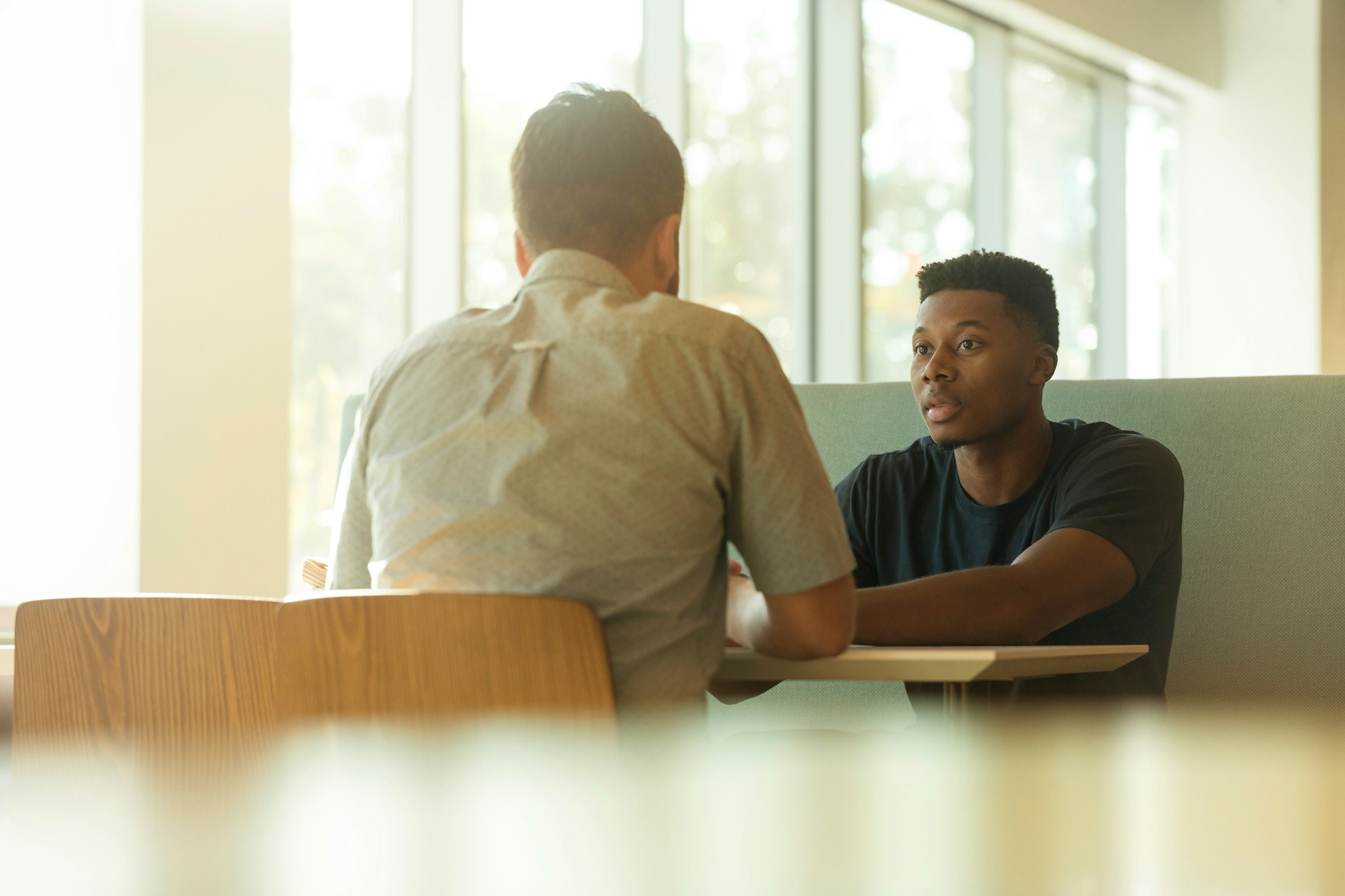 Executive coach and senior leader in one-on-one session at a boardroom table 